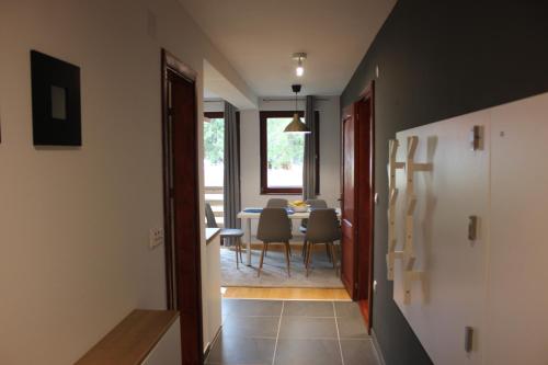 a hallway leading to a dining room with a table at 4 Seasons Vlašić Lux Apartments in Vlasic