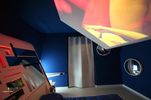 a blue room with a bed and a shower at Diecizero Affittacamere in Barùmini
