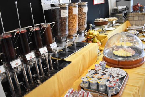 a buffet of food on a yellow table at Hotel Sant'Elia in SantʼElia Fiumerapido