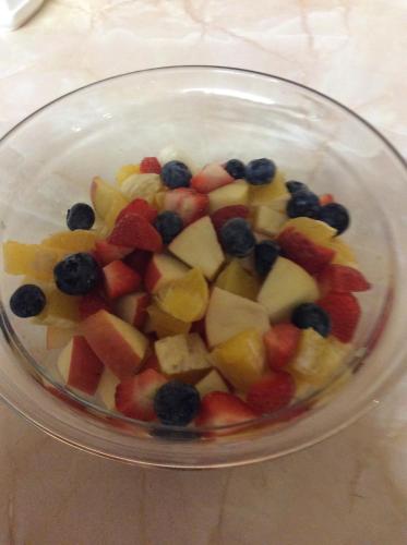 a glass bowl filled with fruits and berries on a table at Monastery View in Bunacurry