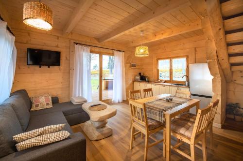 a living room with a couch and a table in a cabin at Osada Sudecka in Lądek-Zdrój