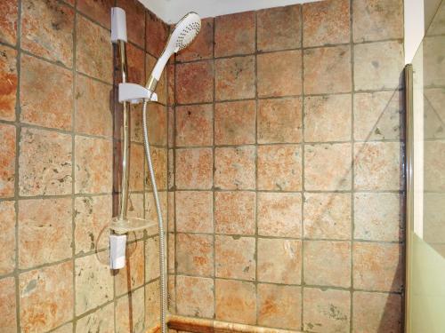 a shower with a shower head in a bathroom at le Travertin in Avignon