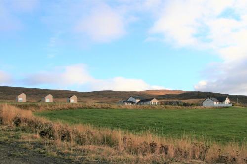a group of houses in the middle of a field at Sunnuhlid houses in Akureyri