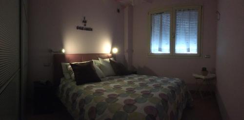 a bedroom with a large bed with a window at L`ATTICO Apartments in Civitanova Marche