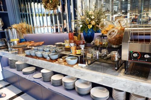 a buffet line with white plates and other items at Glam Habitat - SHA Extra Plus in Kamala Beach