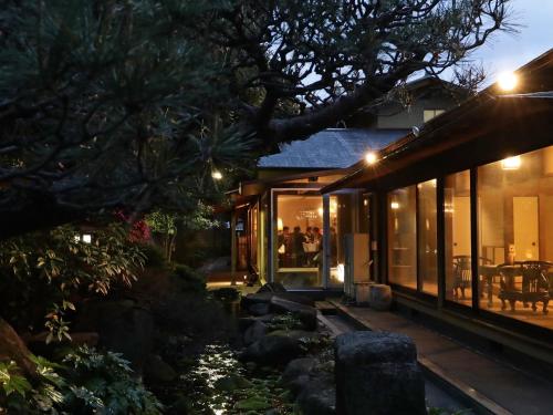 a house with glass doors on the side of it at Nara Royal Hotel in Nara