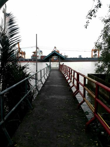 a bridge over a body of water next to a fence at Baan Glangsuan Bang Kobua in Bang Chak