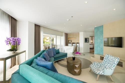 sala de estar con sofá azul y sillas en Grand Mirage Resort & Thalasso Bali - All Inclusive, en Nusa Dua
