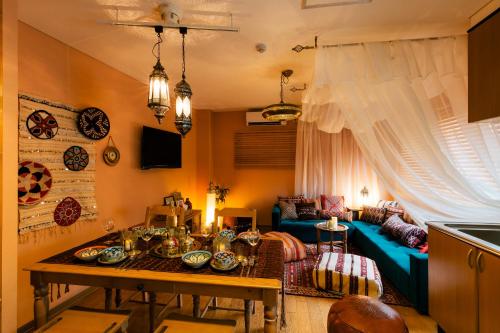 a living room with a table and a couch at Kashikiri Ikkenya YUME in Osaka