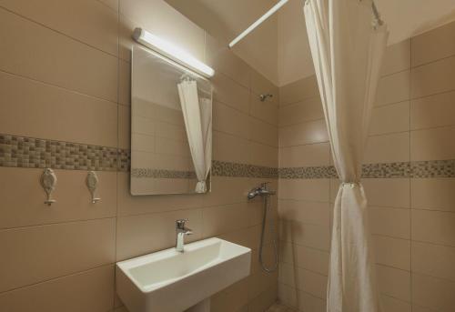 a bathroom with a sink and a mirror at Kristina´s rooms in Rhodes Town