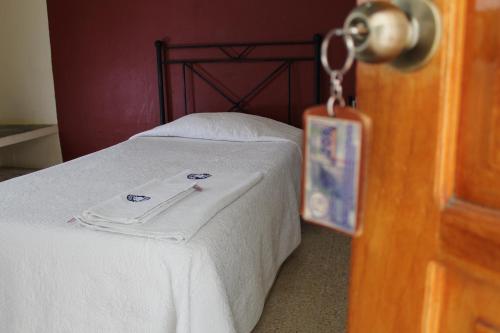 a bedroom with a bed with a towel on it at Hotel Casablanca Tuxtla in Tuxtla Gutiérrez
