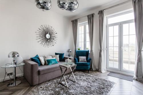 a living room with a couch and a table at Eye of Budapest Penthouse in Budapest
