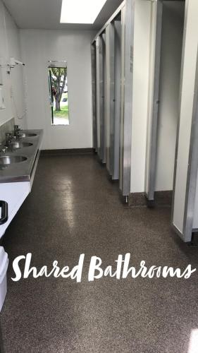 a room with a row of stalls in a bathroom at Twizel Holiday Park in Twizel