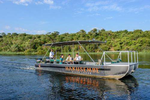 a group of people on a boat on the water at Gondwana Hakusembe River Lodge in Rundu