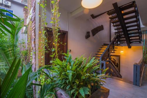 an indoor garden with plants and a staircase at Cambana d'Angkor Suites in Siem Reap