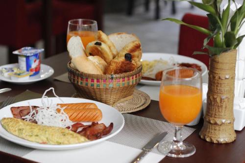 a table with plates of food and a basket of bread at Cambana d'Angkor Suites in Siem Reap