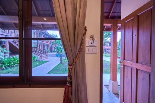 a curtain is hanging in front of a door at Mina Garden Villa Resort in Chiang Mai
