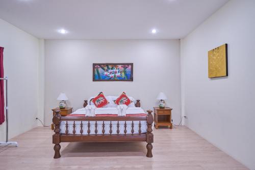 a bedroom with a bed and two night stands at Mina Garden Villa Resort in Chiang Mai
