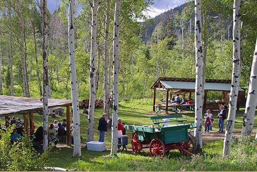 a group of people standing around a group of trees at Parade Rest Ranch in West Yellowstone