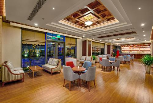a restaurant with chairs and tables in a room at DLG Hotel Danang in Da Nang
