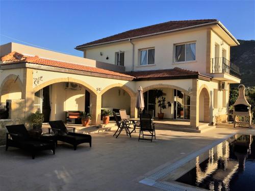 a large house with a swimming pool in front of it at Casa Santos Kyrenia in Kérynia