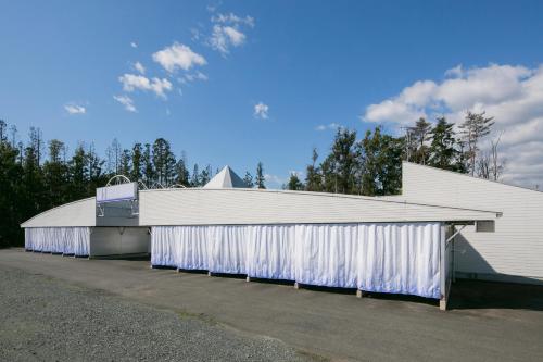 a large white building with a white roof at HOTEL LYISTA (Adult Only) in Hanamaki