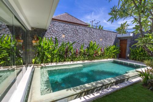 a swimming pool in the backyard of a house at Vishuddha Ajna Villa - Outstanding 2 bdr villa - GREAT LOCATION! in Seminyak