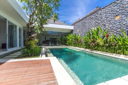 a swimming pool in front of a house at Vishuddha Ajna Villa - Outstanding 2 bdr villa - GREAT LOCATION! in Seminyak