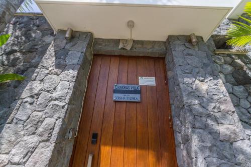 a wooden door with a sign on top of it at Vishuddha Ajna Villa - Outstanding 2 bdr villa - GREAT LOCATION! in Seminyak