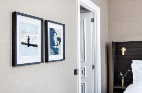 two framed pictures on a wall in a bedroom at Pillows Grand Boutique Hotel Reylof Ghent in Ghent