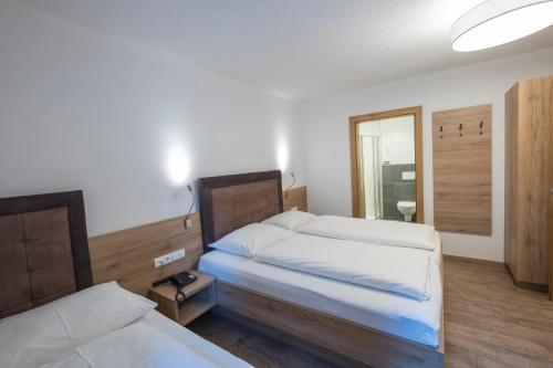 a hotel room with two beds and a mirror at Chasa Allegria in Ischgl