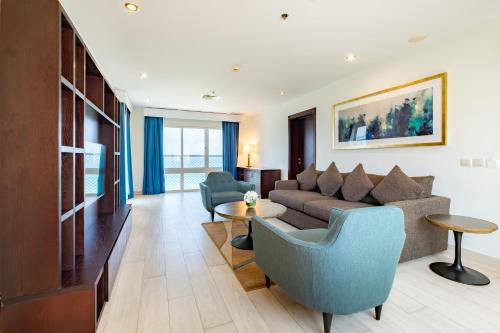 a living room with a couch and a table at Radisson Blu Resort, Fujairah in Dibba