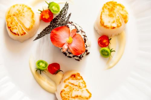 a white plate topped with different types of food at Hotel Villa Del Sogno in Gardone Riviera