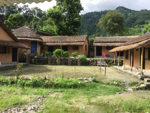 a group of houses with thatched roofs at My beautiful cottage in pokhara in Pokhara