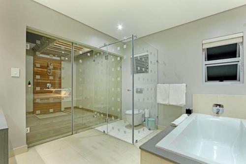 a large bathroom with a tub and a shower at Vetho House Villa Ballito in Ballito