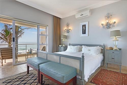 a bedroom with a bed and a view of the ocean at Vetho House in Ballito