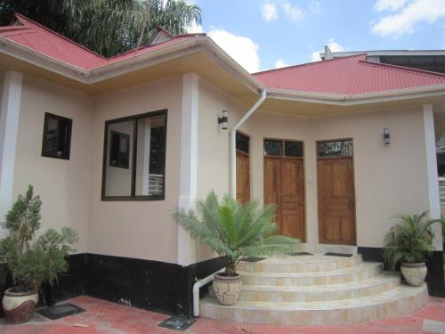 a small house with a red roof at Jakicha Motel in Dar es Salaam