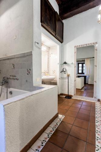 a large bathroom with a tub and a sink at Borgo Il Poggiaccio Residenza d'Epoca in Sovicille