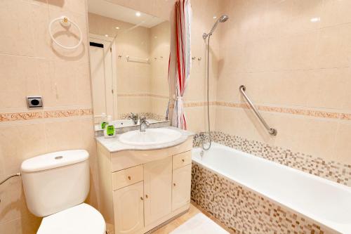 a bathroom with a toilet and a sink and a bath tub at Carabeo P Milenio 1 piso 2 1 sea view in Nerja