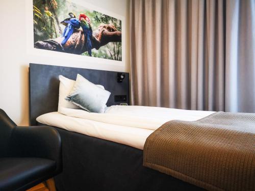 a hotel room with a bed and a picture on the wall at Best Western Plaza Hotel in Eskilstuna