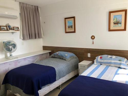 a bedroom with two beds and a window at Aquaville Resort in Mangabeira