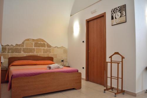 a bedroom with a bed with a stuffed animal on it at Borgo Saraceno in Spinazzola