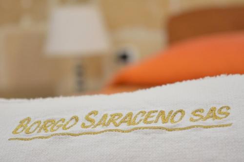 a white blanket with the words angel emergencysama on it at Borgo Saraceno in Spinazzola