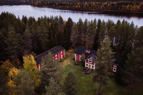an aerial view of a house on the edge of a lake at Rehto in Rovaniemi