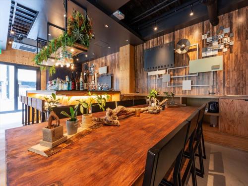 a bar with a wooden table in a room at Focus Kuramae in Tokyo