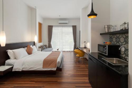 a hotel room with a bed and a sink at TAO Riverside Residence in Phnom Penh