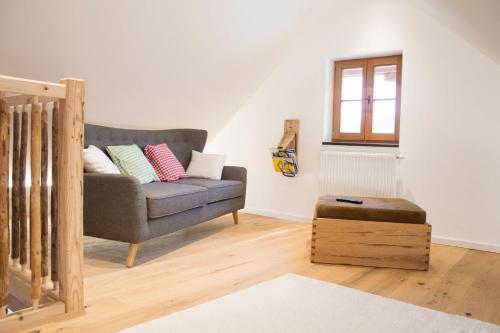 a living room with a couch and a window at Gesindehaus in Diemlern
