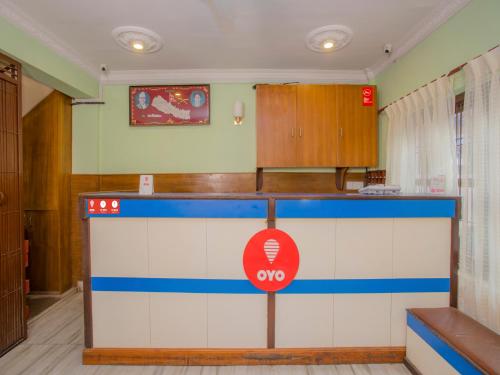 a kitchen with a counter with a sign on it at Waling Fulbari Guest House in Bālāju