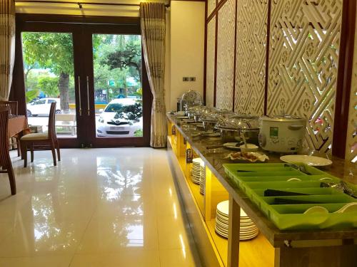 a kitchen with a counter with green dishes on it at Phoenix3 Hotel Bắc ninh in Bắc Ninh