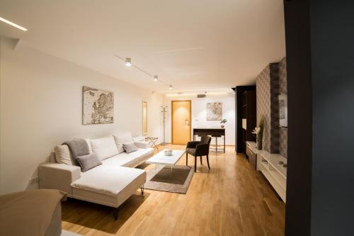 a living room with a white couch and a table at Belgrade Center Luxury Apartments in Belgrade